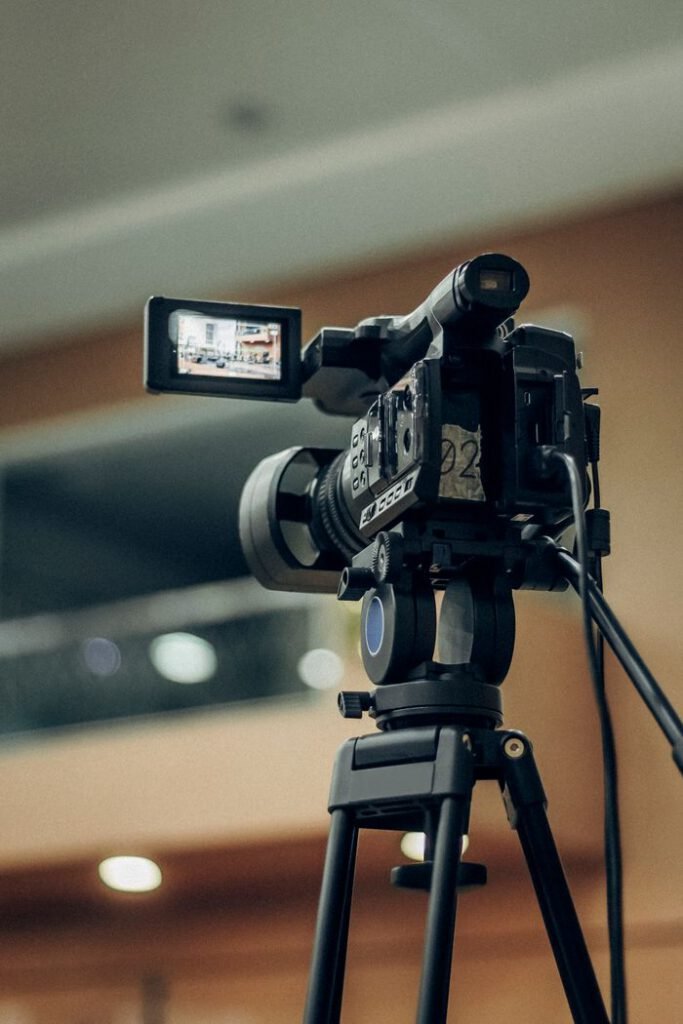 pexels photo 26803902 A high-quality video camcorder setup on a tripod for indoor filming.