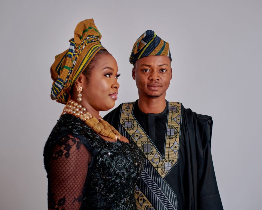 pexels photo 32712036 A stylish couple in traditional African garments posing confidently indoors.