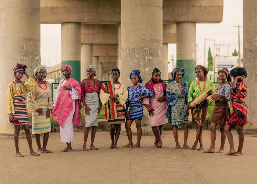pexels photo 33489869 A group of women in vibrant traditional African attire pose under a bridge.