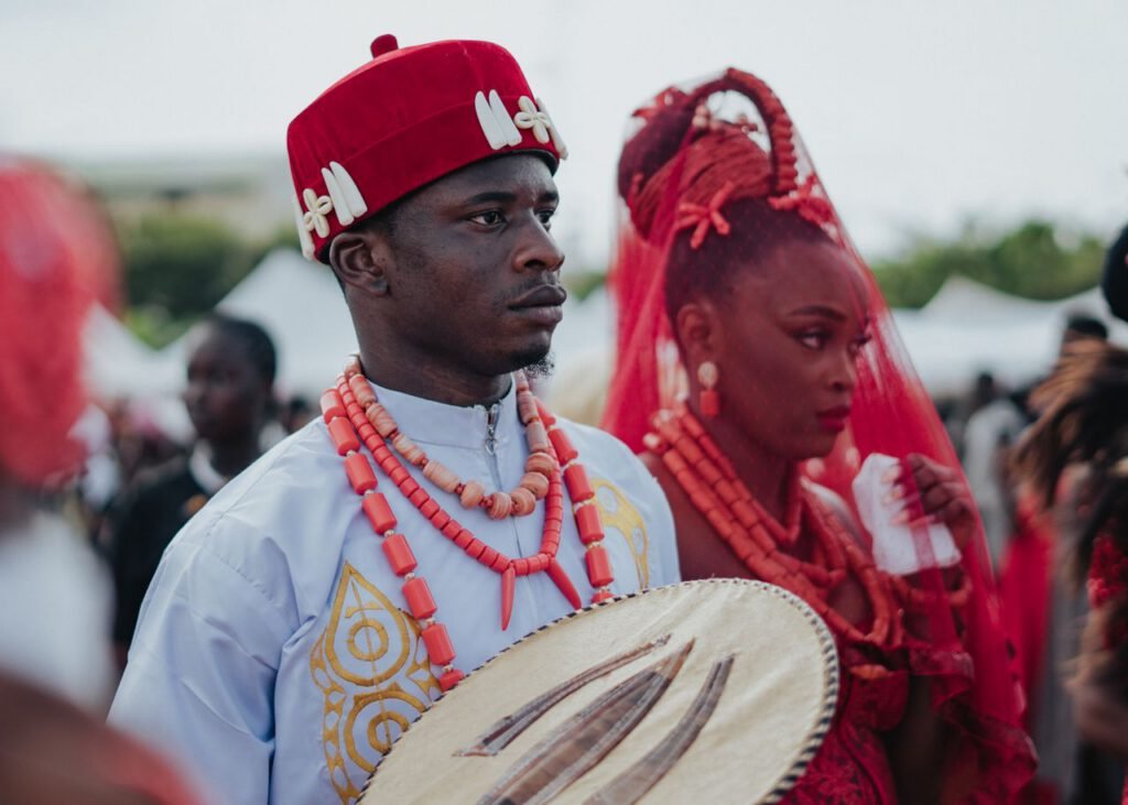A captivating scene of Nigerian traditional wedding with vibrant attire and cultural drum.